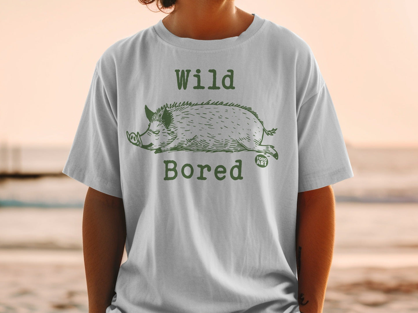 T-shirt with green illustration of a wild boar and text "Wild Bored".