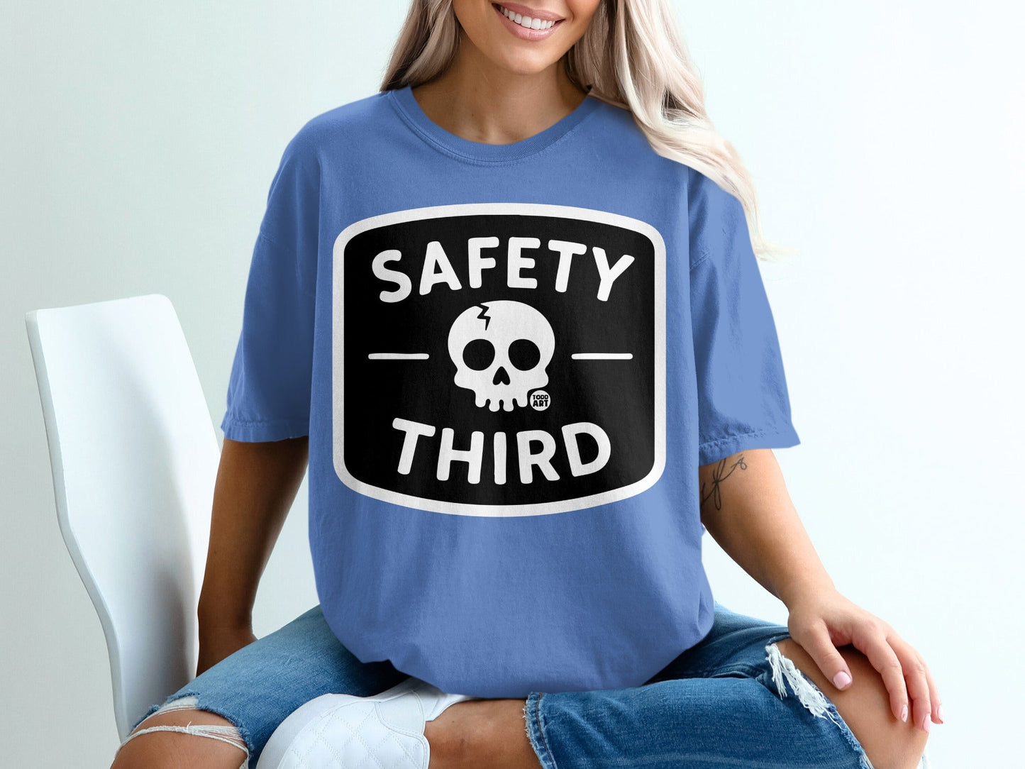 Blue t-shirt with black square logo featuring a skull and "SAFETY THIRD".