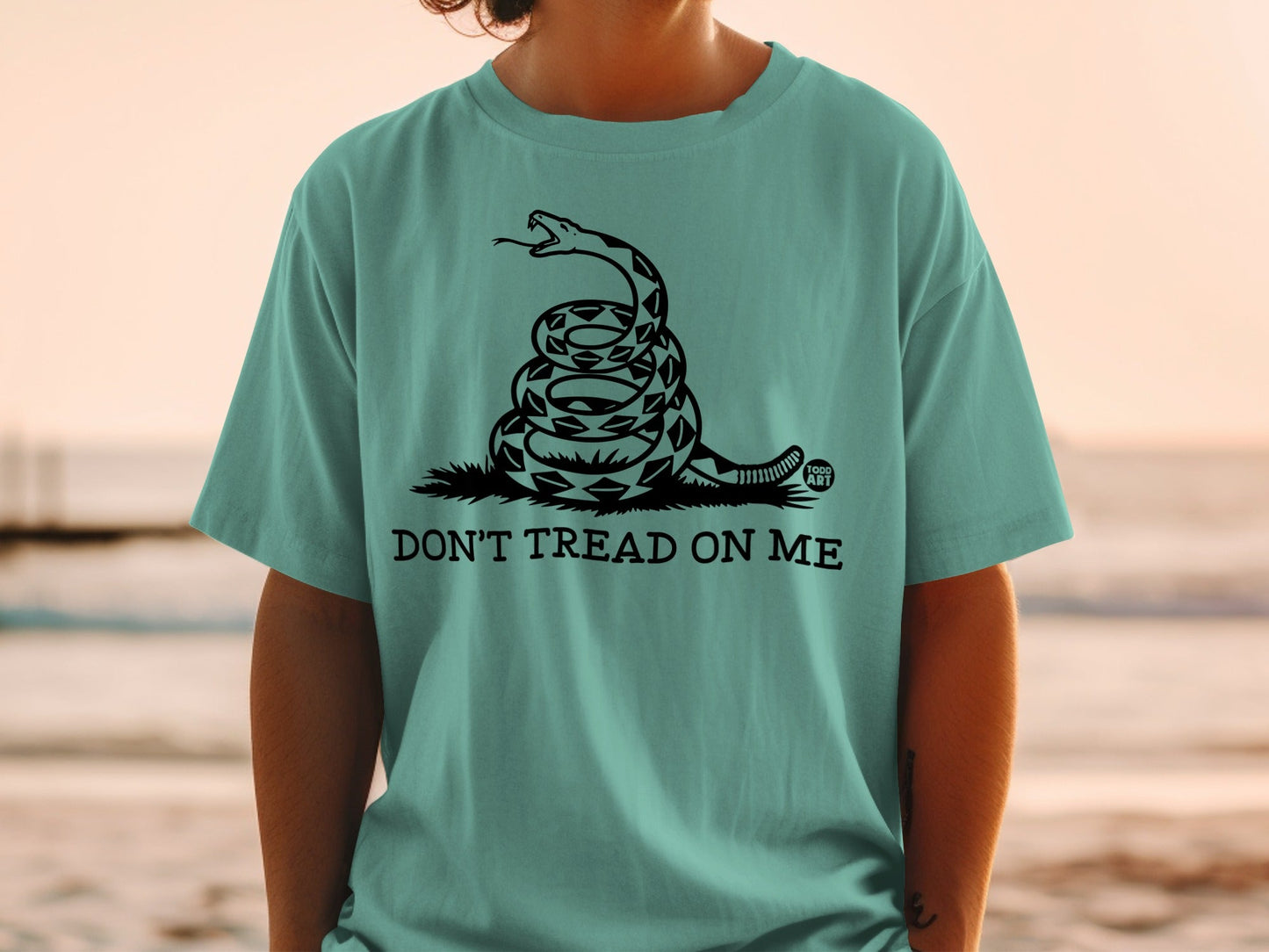 Teal t-shirt with coiled rattlesnake and "Don't Tread On Me" text.