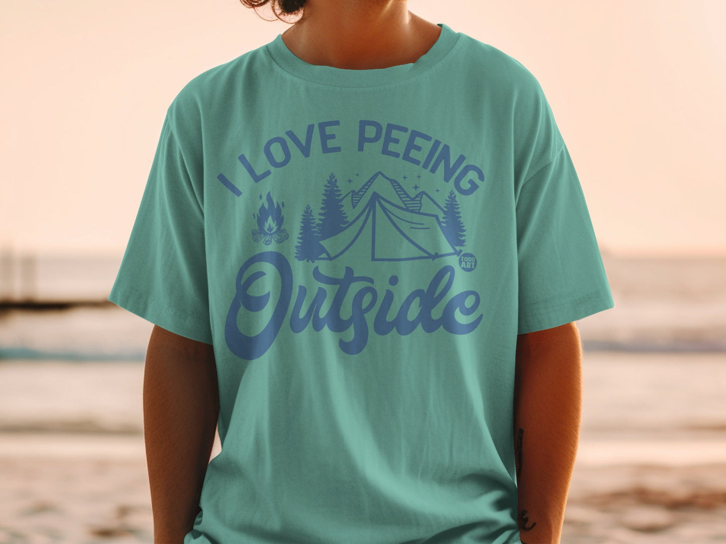 Teal t-shirt with "I Love Peeing Outside" text and camping graphics.