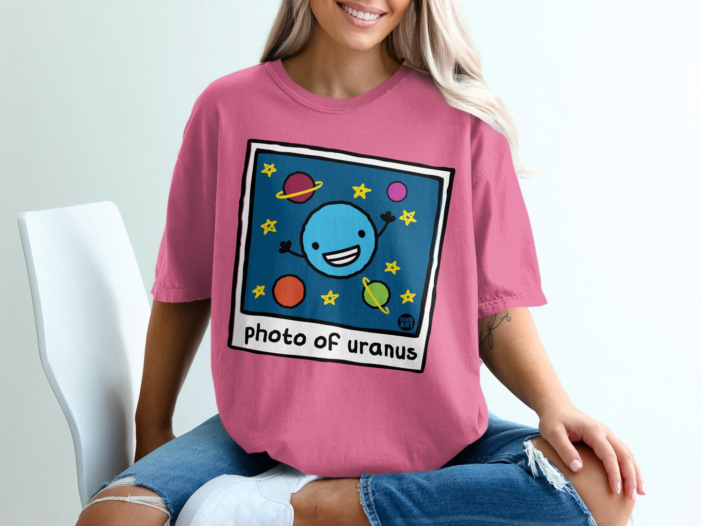 Cartoon photo of smiling Uranus with stars and planets.