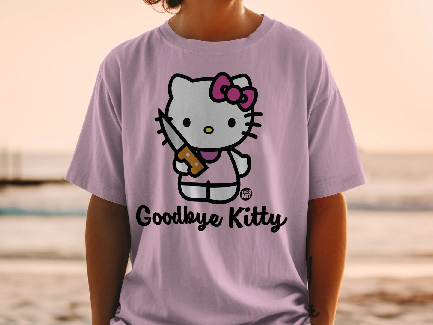 Hello Kitty wearing a pink bow and holding a knife on a purple shirt.
