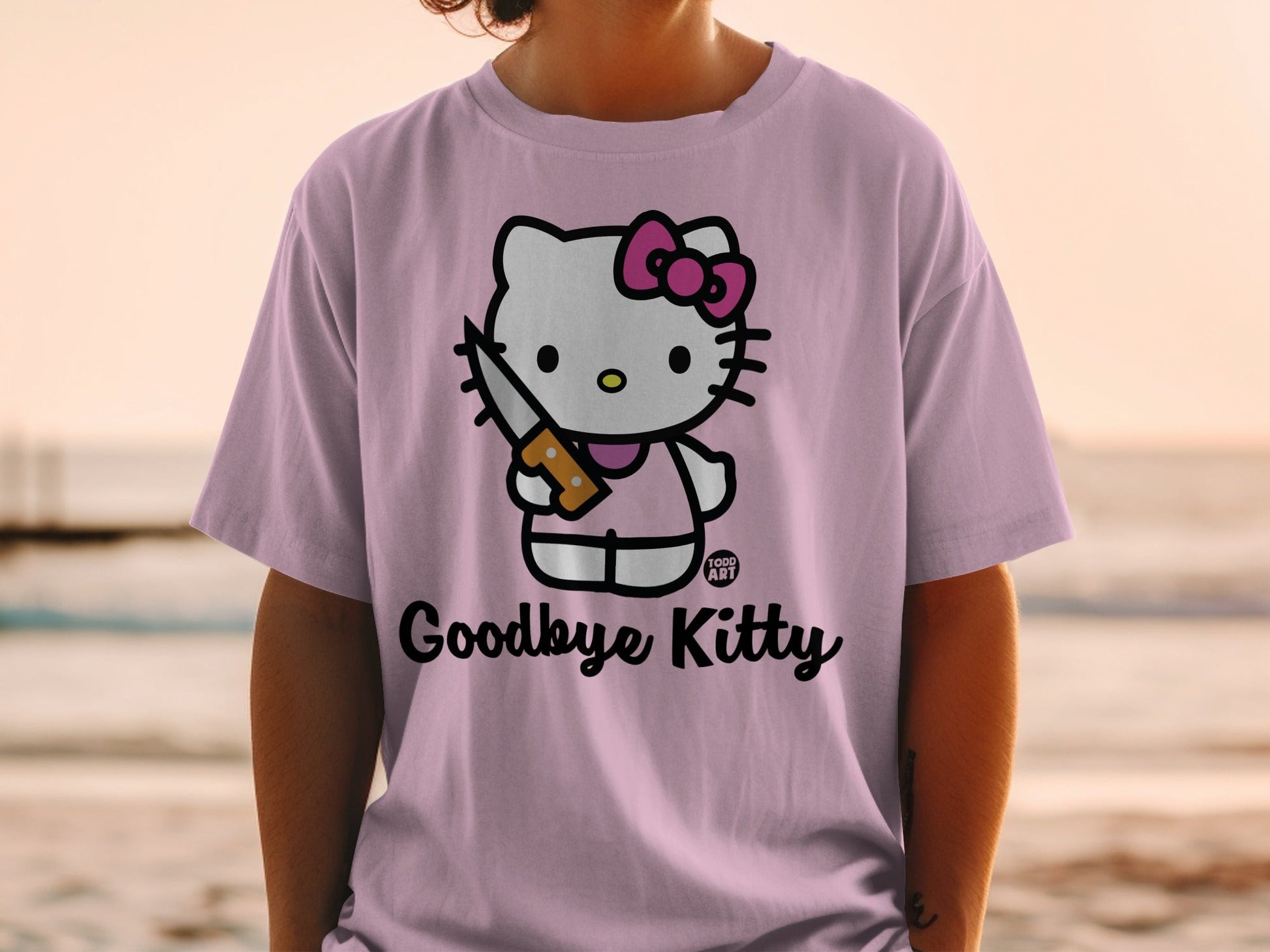 Hello Kitty wearing a pink bow and holding a knife on a purple shirt.