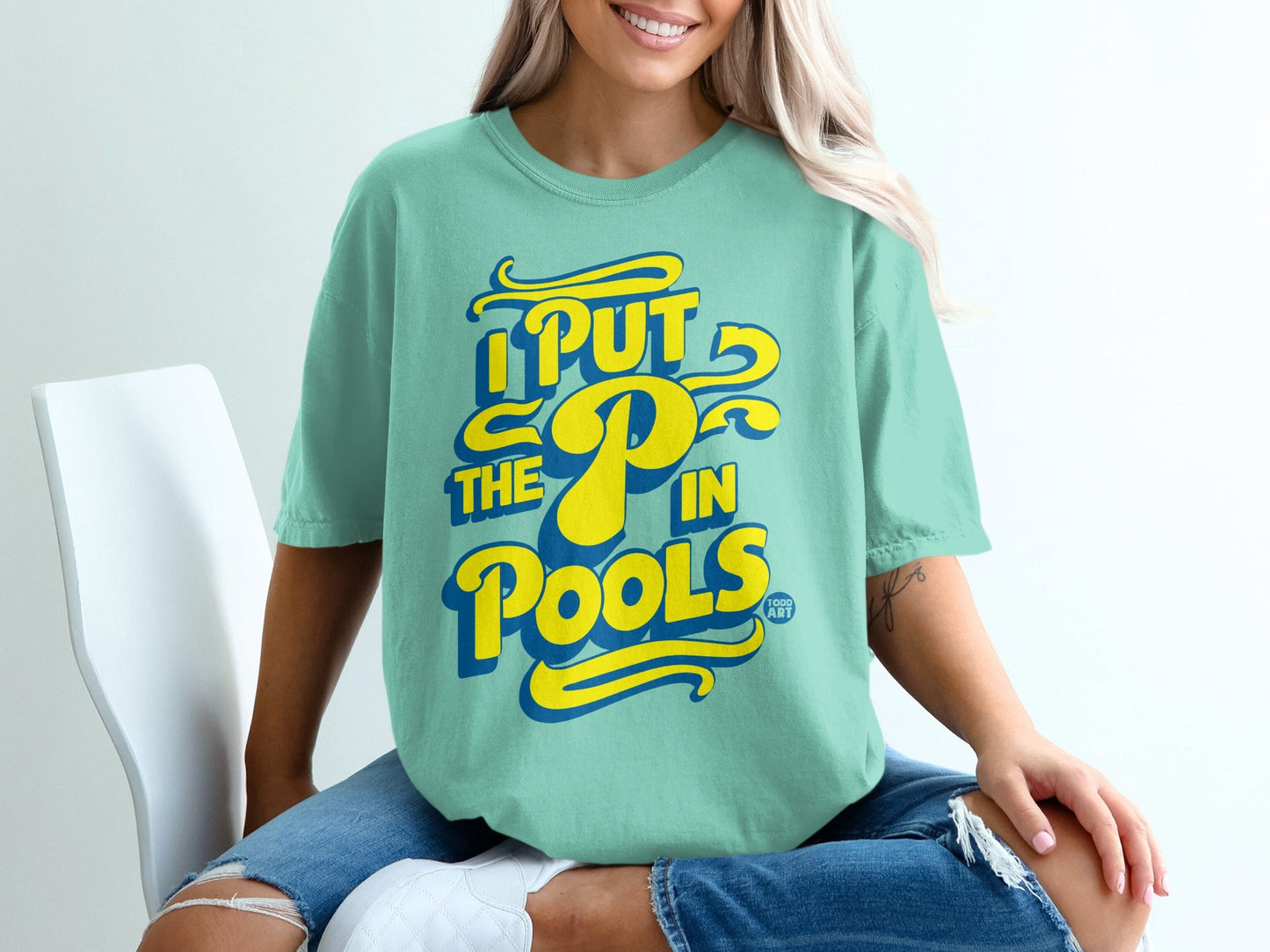 Mint t-shirt with yellow text reading "I PUT THE P IN POOLS".