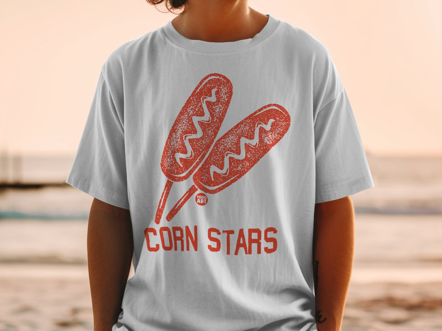 White t-shirt with red corn dog graphic and "CORN STARS" text.