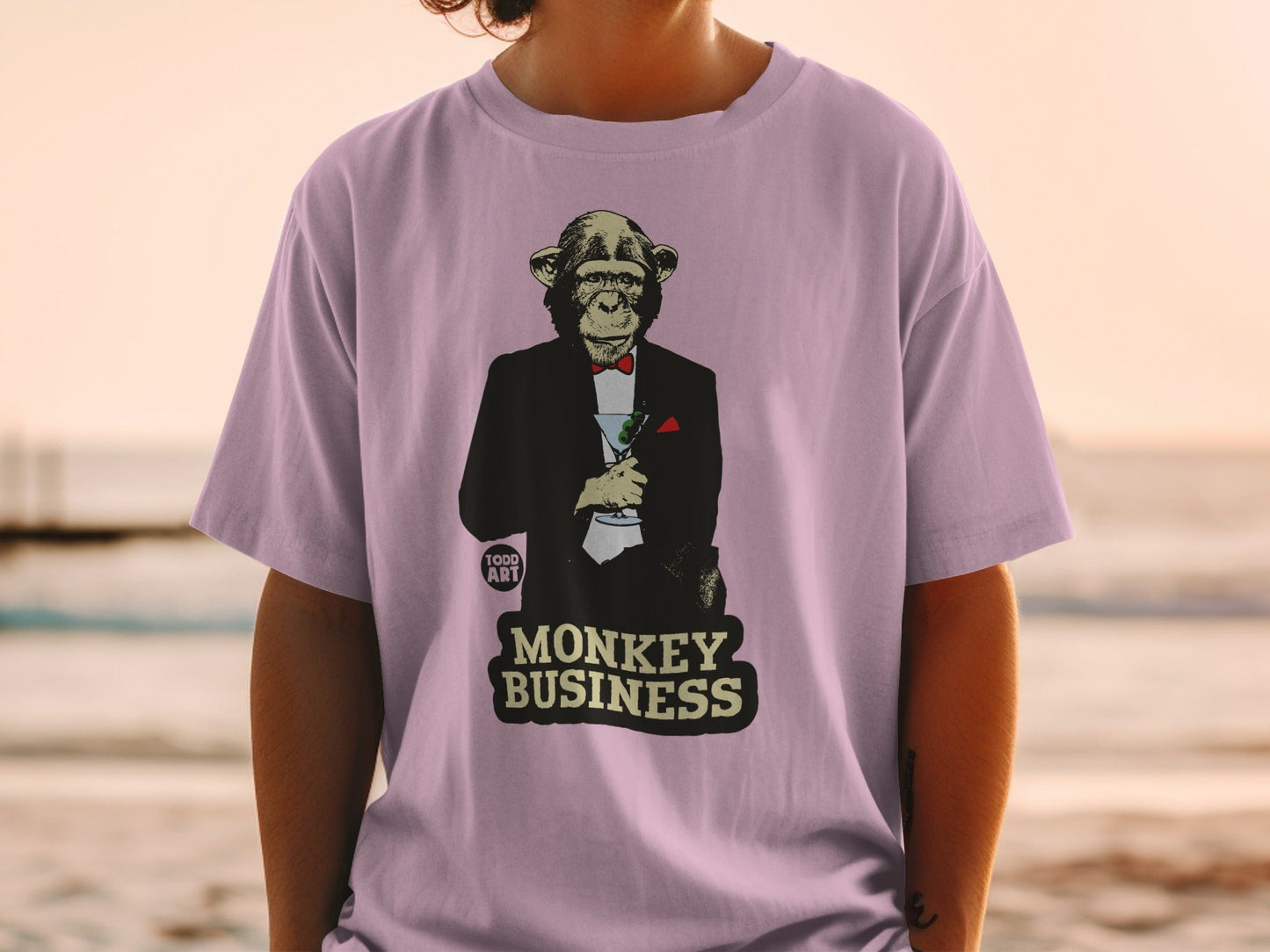 T-shirt with a monkey in a tuxedo holding a martini, text reads "MONKEY BUSINESS".