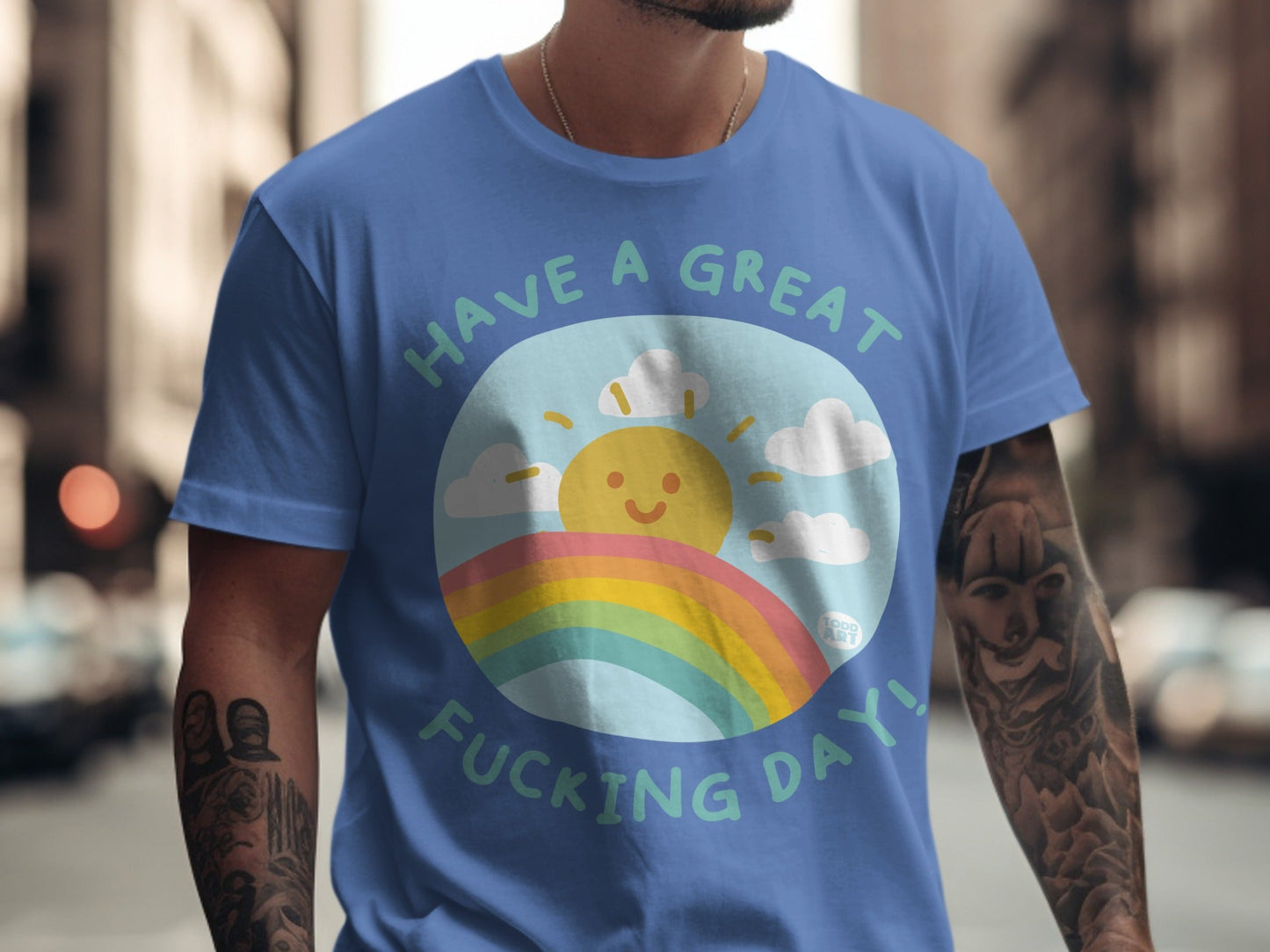 Blue t-shirt with sun, rainbow, clouds, and "Have a Great Fucking Day!" text.