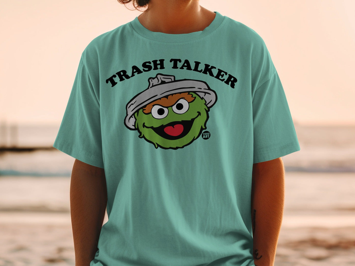 Oscar the Grouch "Trash Talker" t-shirt on a person at the beach.