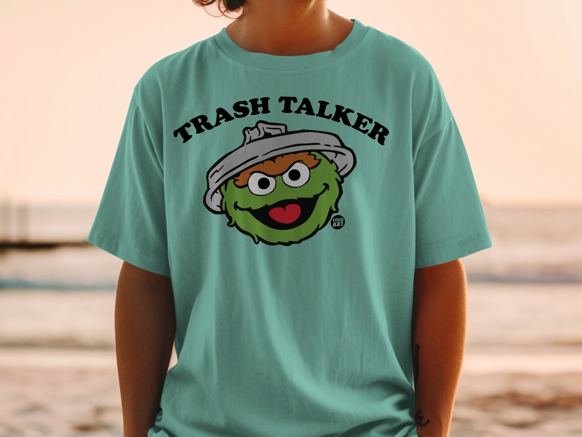 Oscar the Grouch "Trash Talker" t-shirt on a person at the beach.
