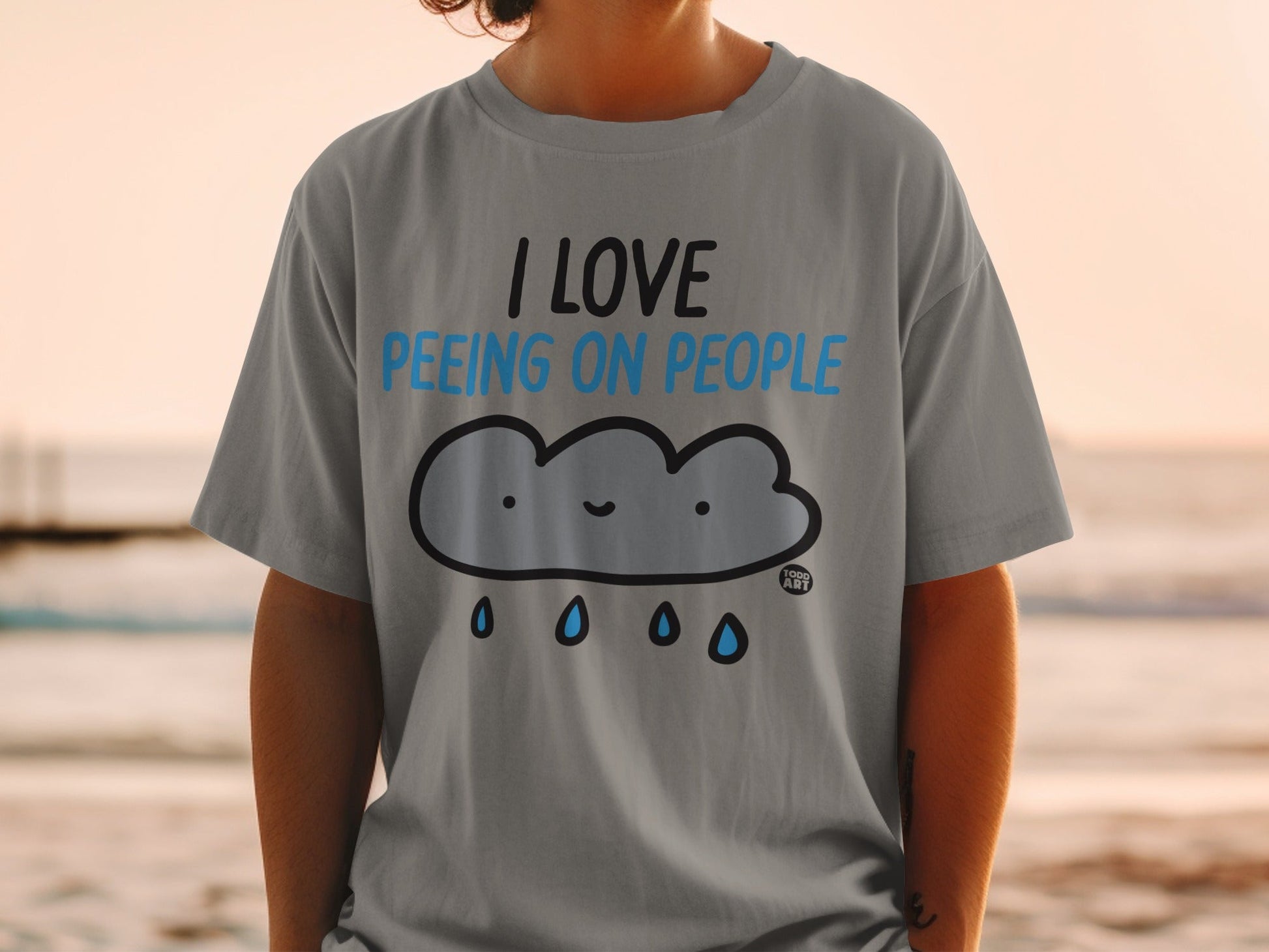 Grey t-shirt with cartoon cloud and text "I love peeing on people."