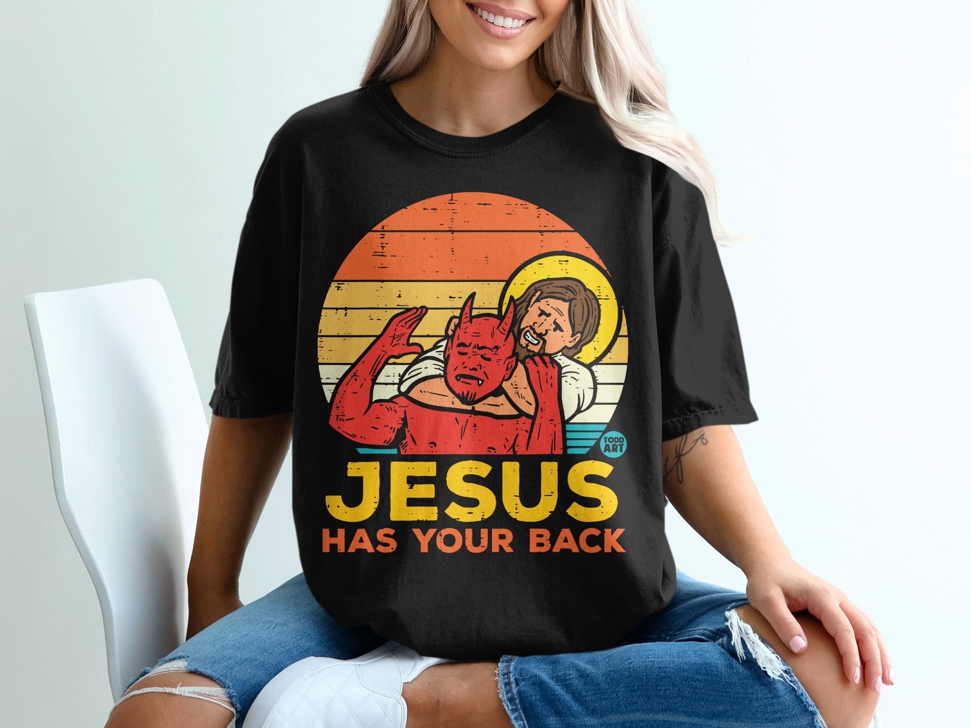 Jesus embracing a devil figure with text "JESUS HAS YOUR BACK".