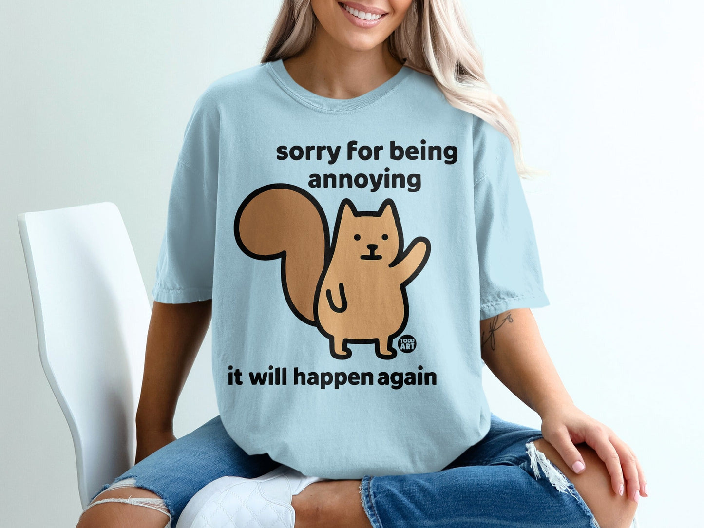 Light blue t-shirt with cartoon squirrel and text "sorry for being annoying it will happen again".