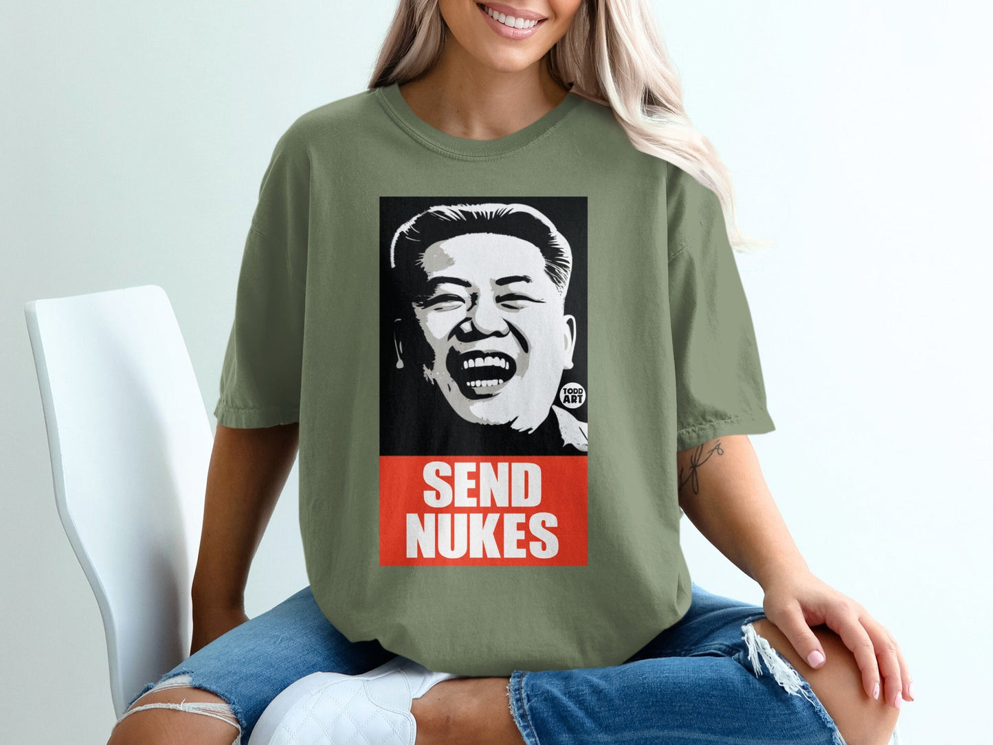 T-shirt with graphic of Kim Jong Un laughing, text "SEND NUKES".