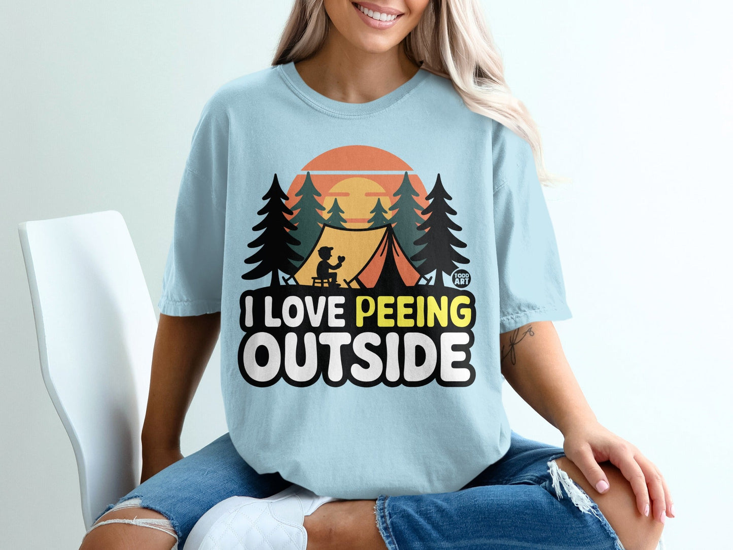 Light blue t-shirt with "I Love Peeing Outside" text and camping graphic.