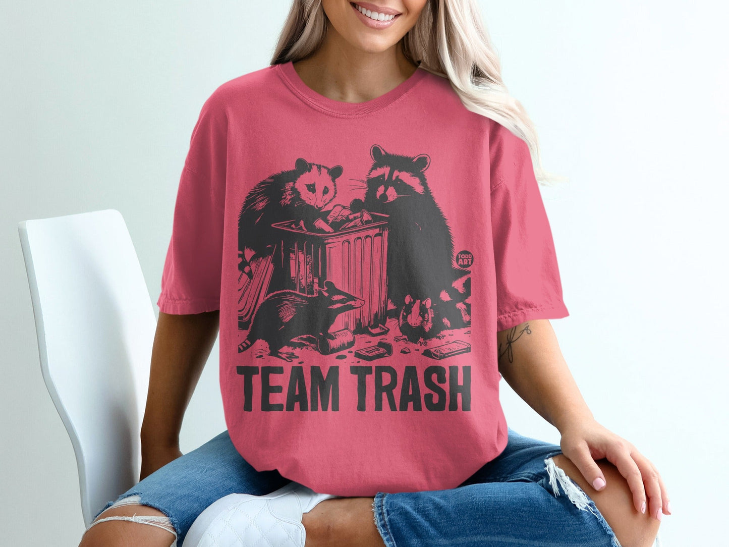 T-shirt with "TEAM TRASH" text and raccoons and opossum graphic.