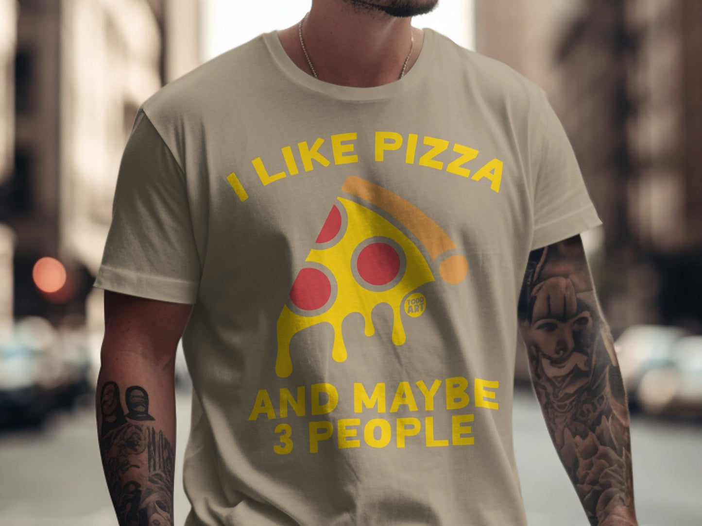 T-shirt with text "I like pizza and maybe 3 people" and pizza slice graphic.