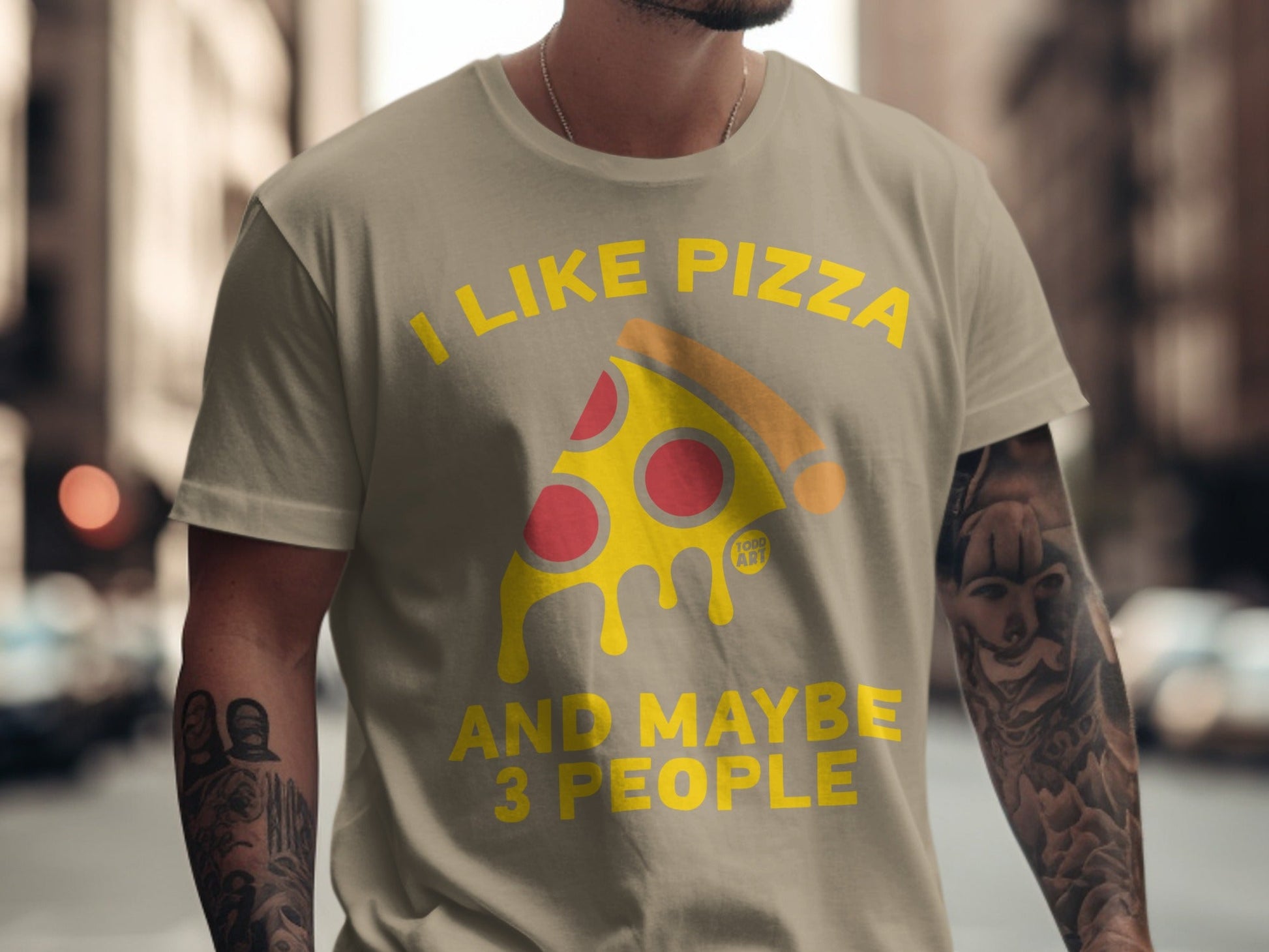 T-shirt with text "I like pizza and maybe 3 people" and pizza slice graphic.