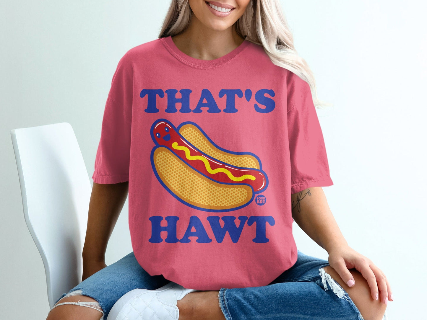Pink t-shirt with cartoon hot dog and text "THAT'S HAWT".