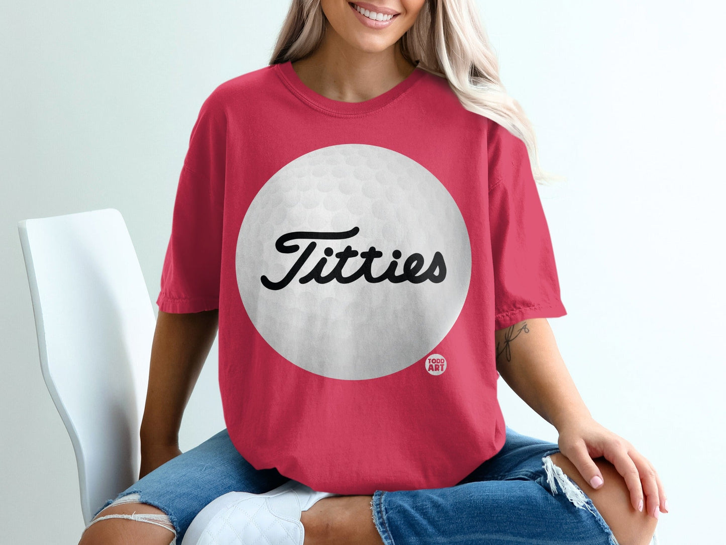 Crimson t-shirt with "Titties" text and golf ball graphic.