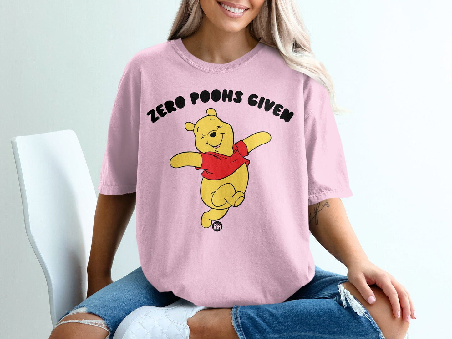 Winnie the Pooh wearing a pink t-shirt with "ZERO POOHS GIVEN" text.