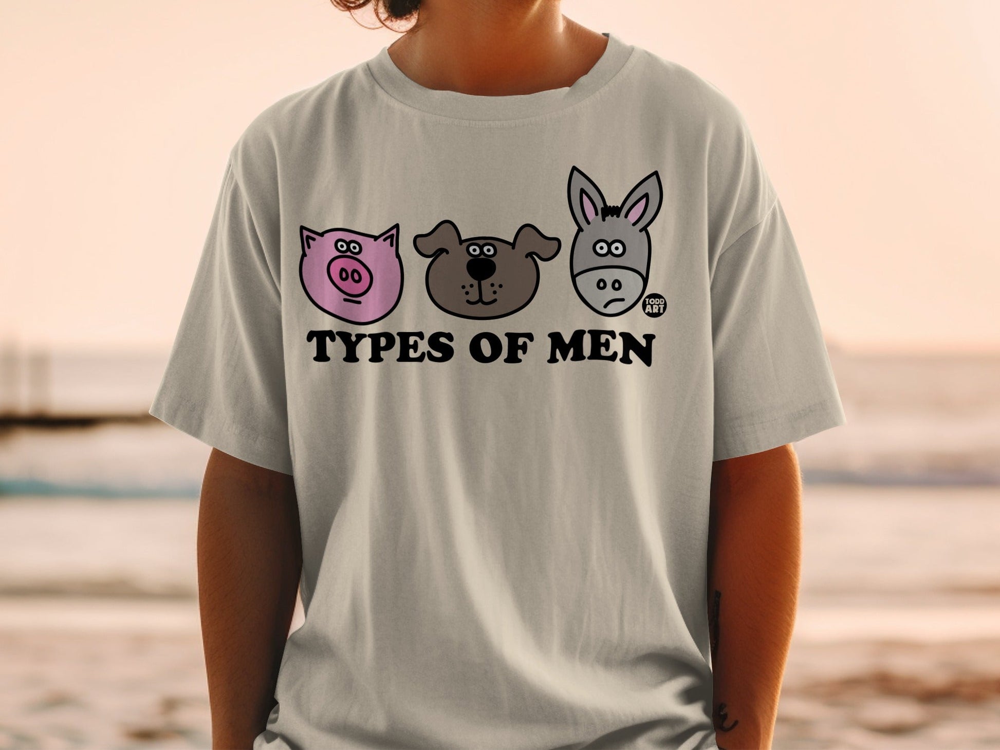 T-shirt with cartoon pig, dog, and donkey faces and "Types of Men" text.