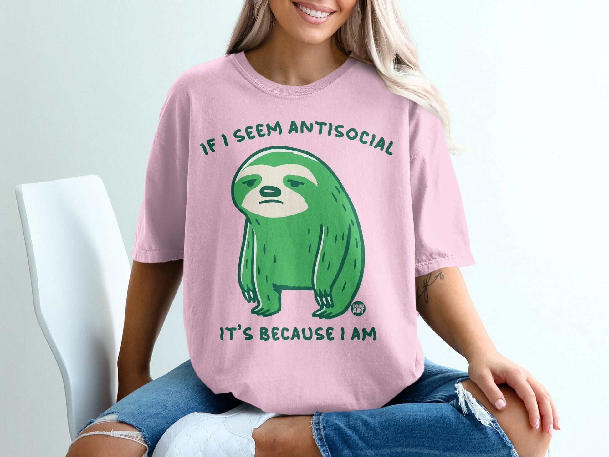 Pink t-shirt with green sloth and text "IF I SEEM ANTISOCIAL IT'S BECAUSE I AM".