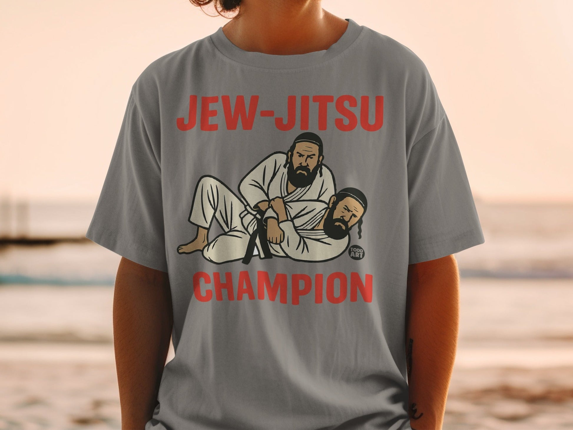 Two men in Jewish attire grappling on a gray t-shirt.