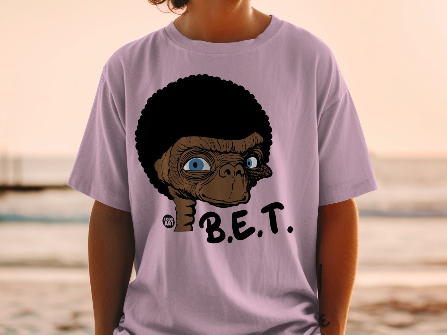 E.T. character on a purple t-shirt with "B.E.T." text.