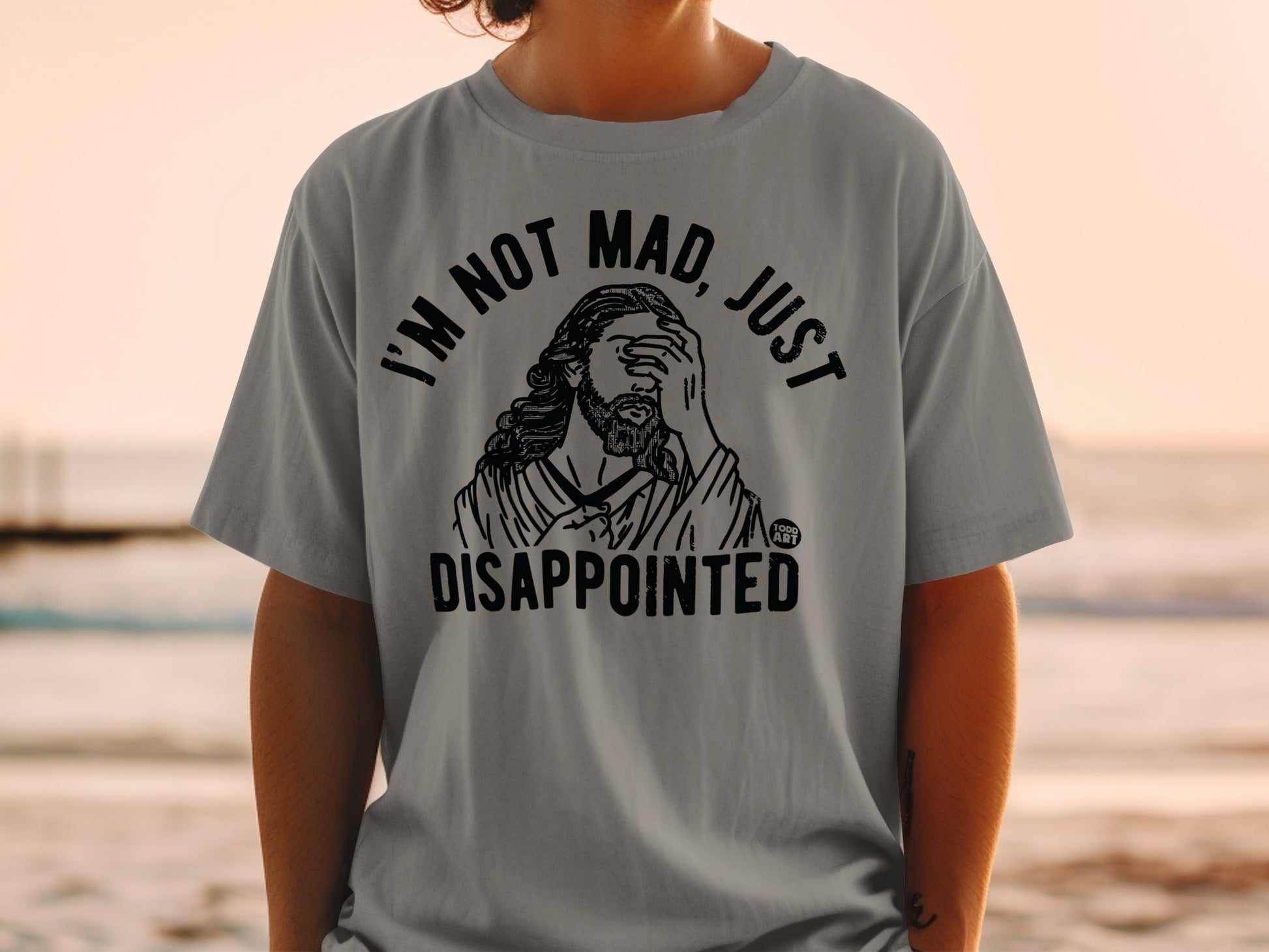 Grey t-shirt with "I'm not mad, just disappointed" text and Jesus graphic.