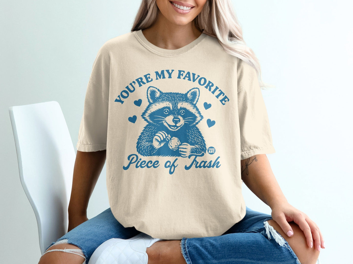 T-shirt with raccoon and "You're my favorite piece of trash" text.