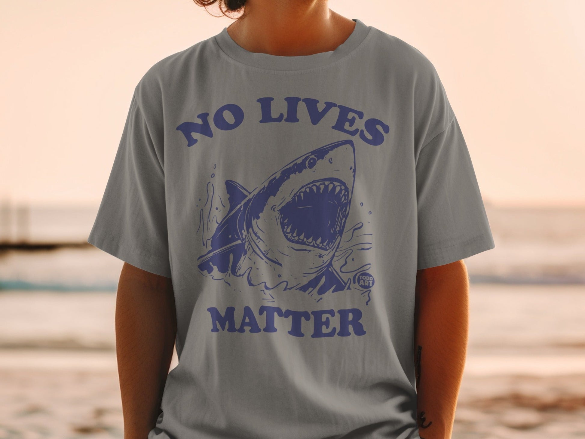 Gray t-shirt with blue shark graphic and "NO LIVES MATTER" text.