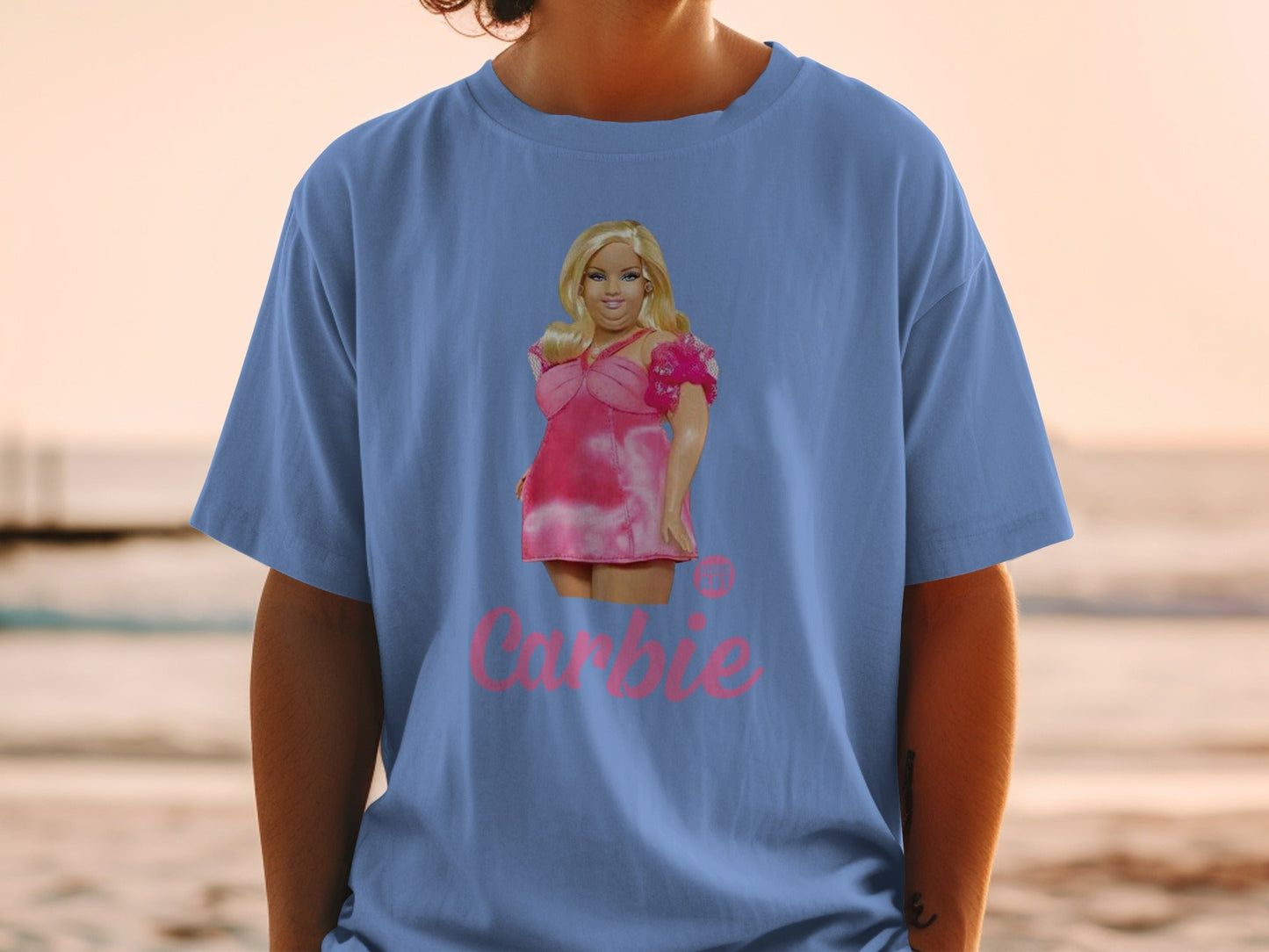 Blue t-shirt with Barbie's face and pink text.