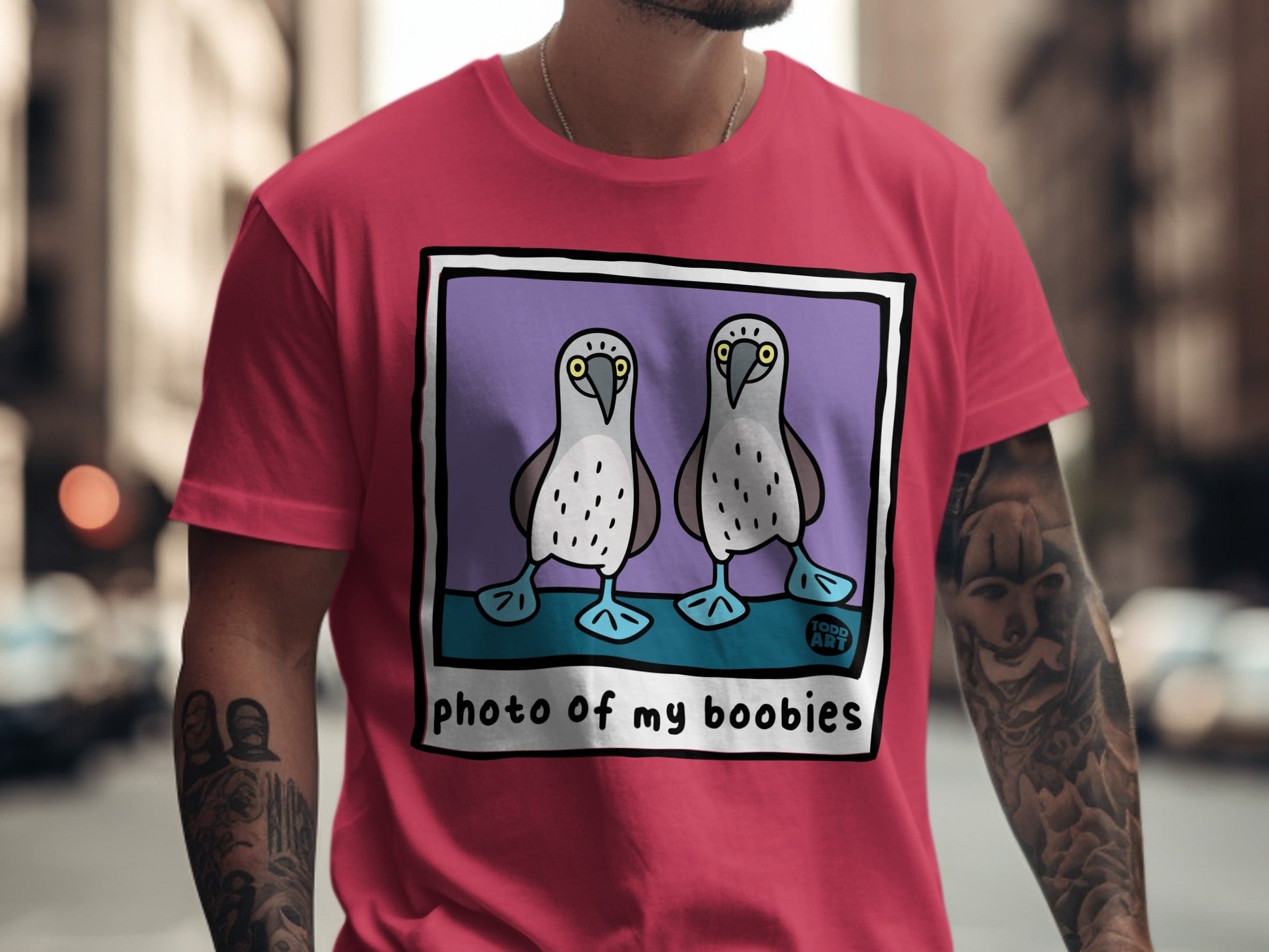 T-shirt with cartoon illustration of two blue-footed booby birds.