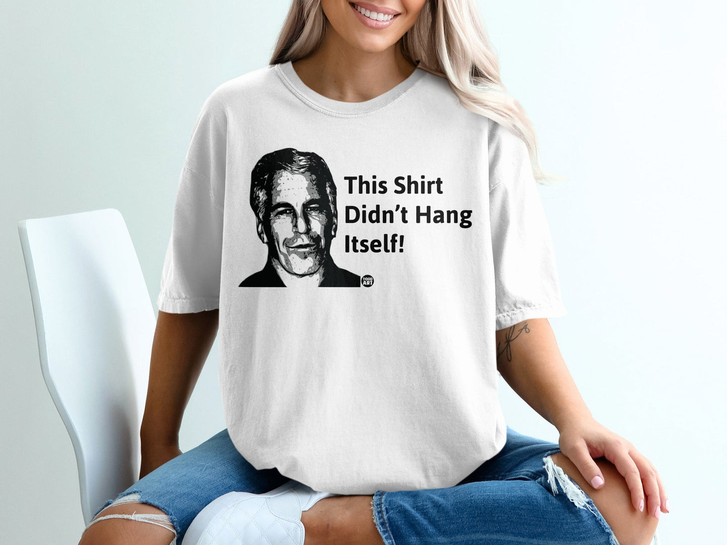 White t-shirt with a black and white portrait and "This Shirt Didn't Hang Itself!"
