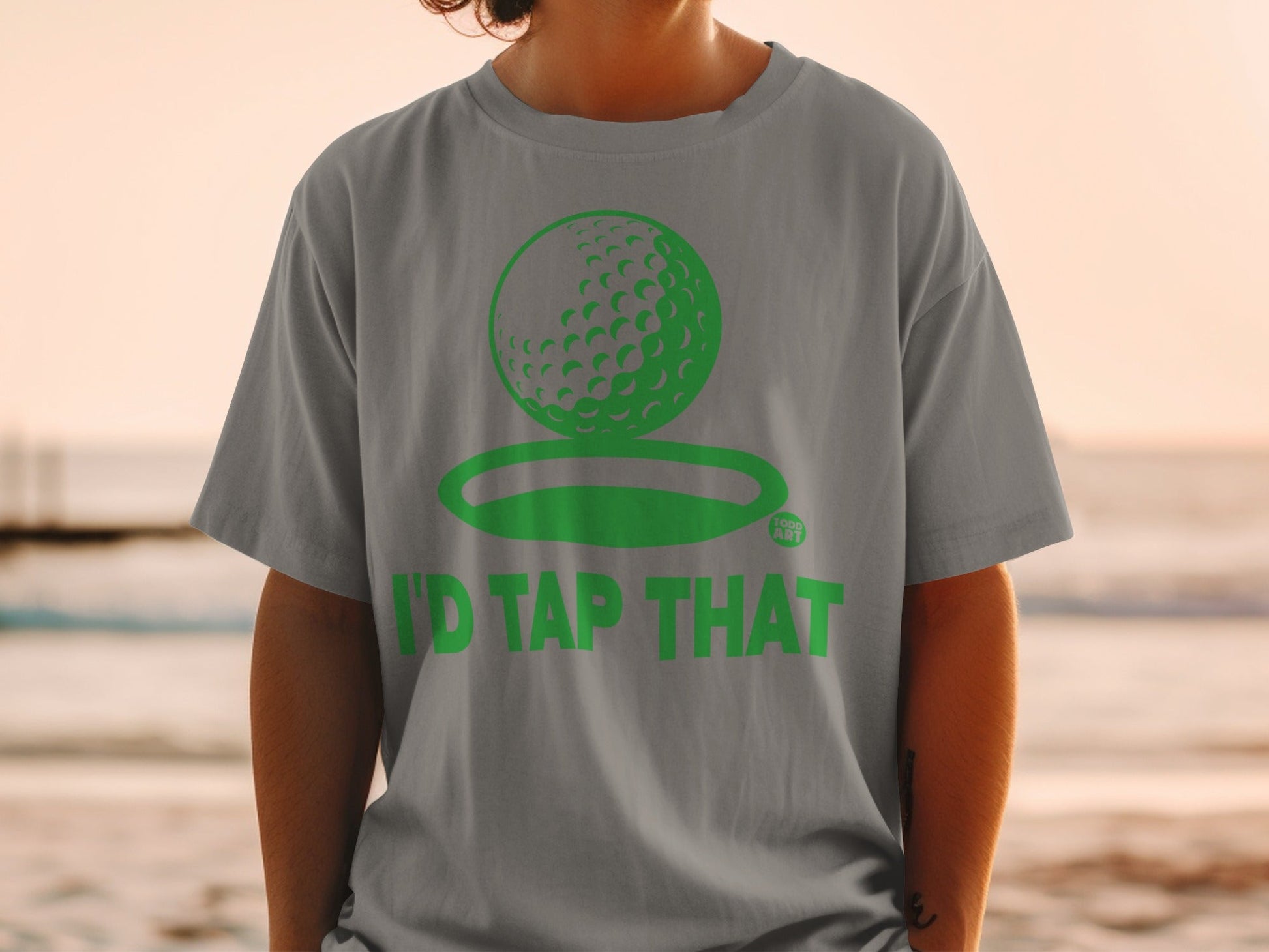Gray t-shirt with green golf ball and "I'd Tap That" text.