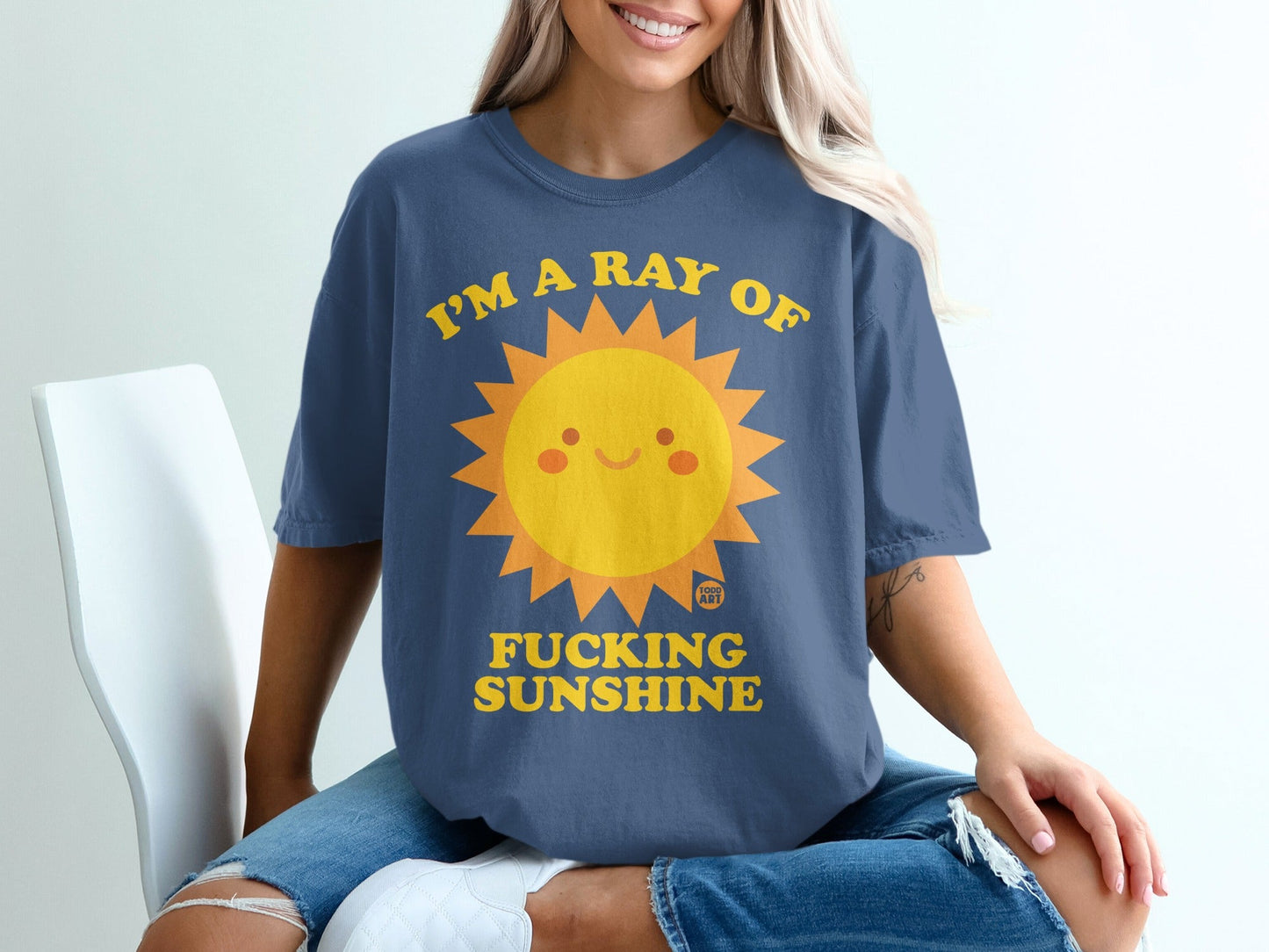 Blue t-shirt with "I'm a ray of fucking sunshine" and smiling sun graphic.