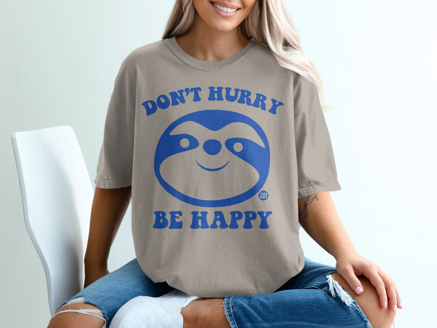 Comfort Colors t-shirt with "Don't Hurry Be Happy" sloth graphic.