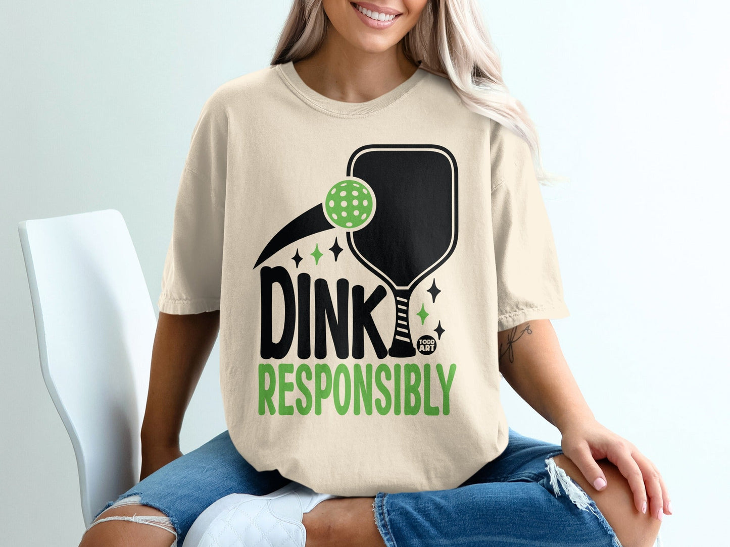 T-shirt with pickleball paddle, ball, and text "DINK RESPONSIBLY".