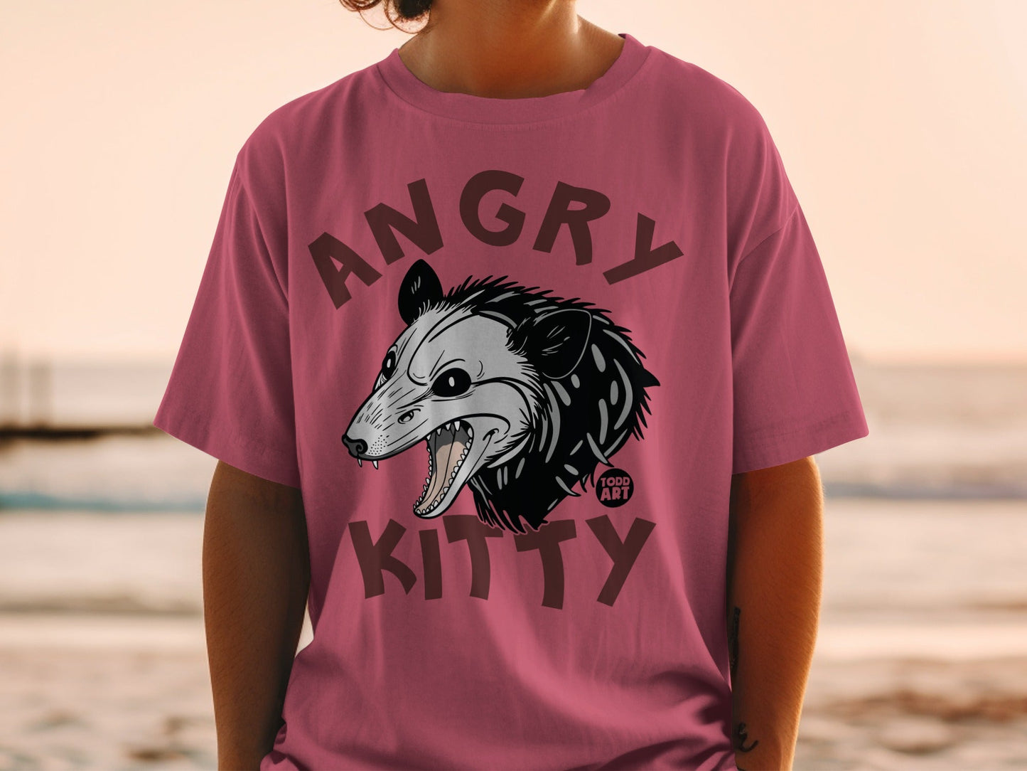 T-shirt featuring a snarling possum head graphic with "ANGRY KITTY" text.