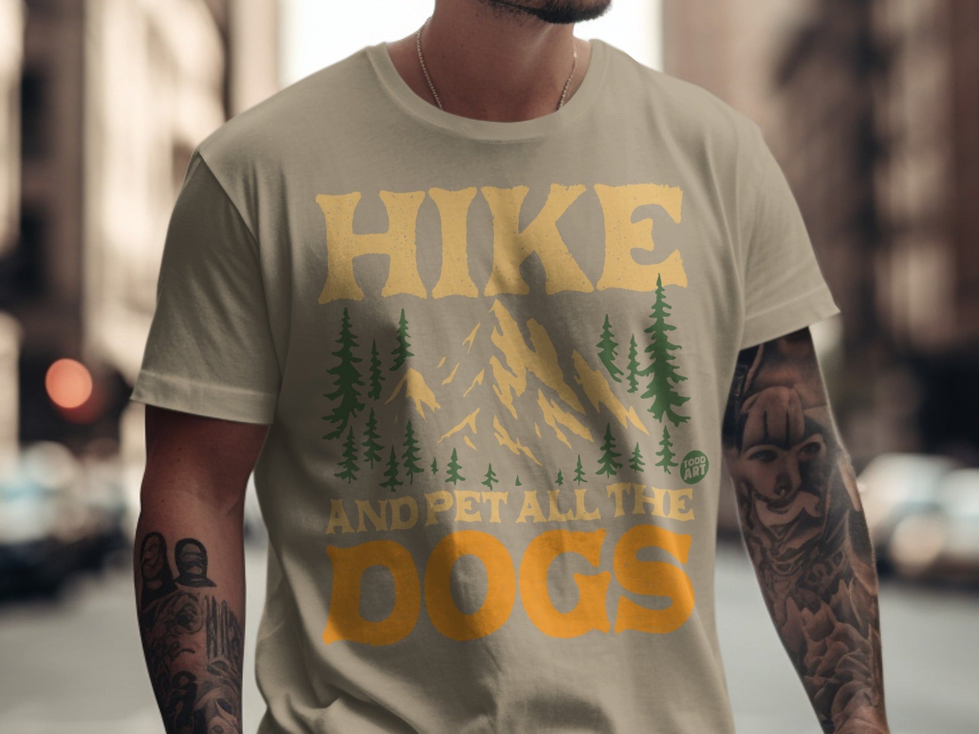 T-shirt with "Hike and Pet All the Dogs" text and mountain graphic.