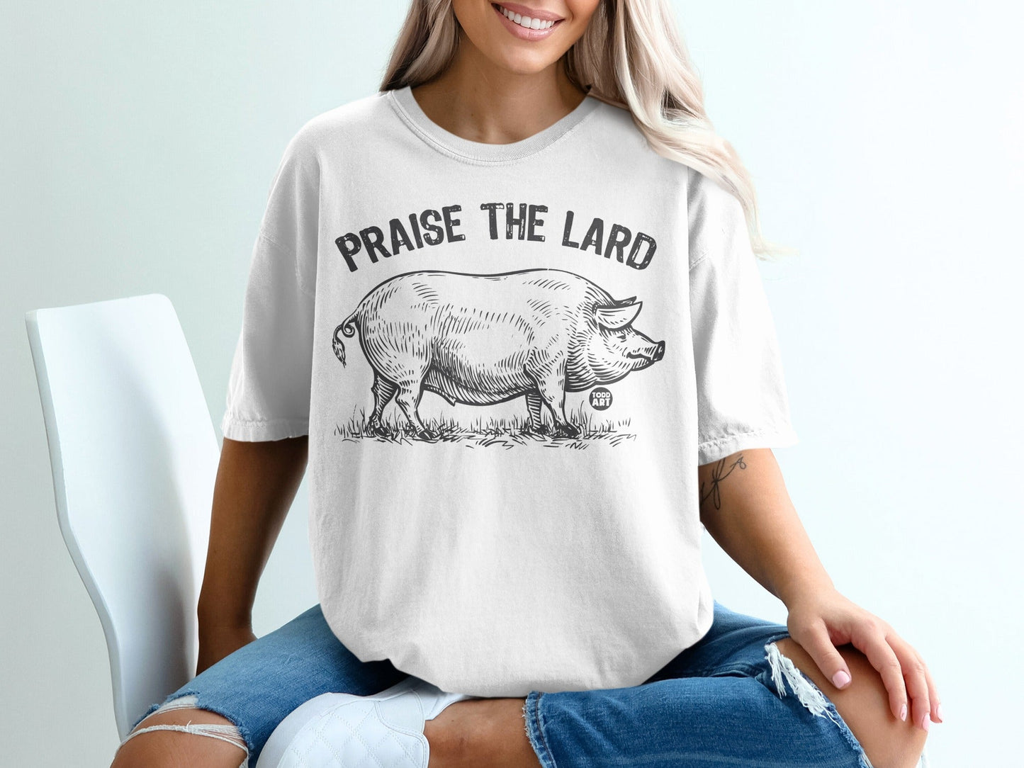 White t-shirt with "Praise the Lard" text and a pig illustration.
