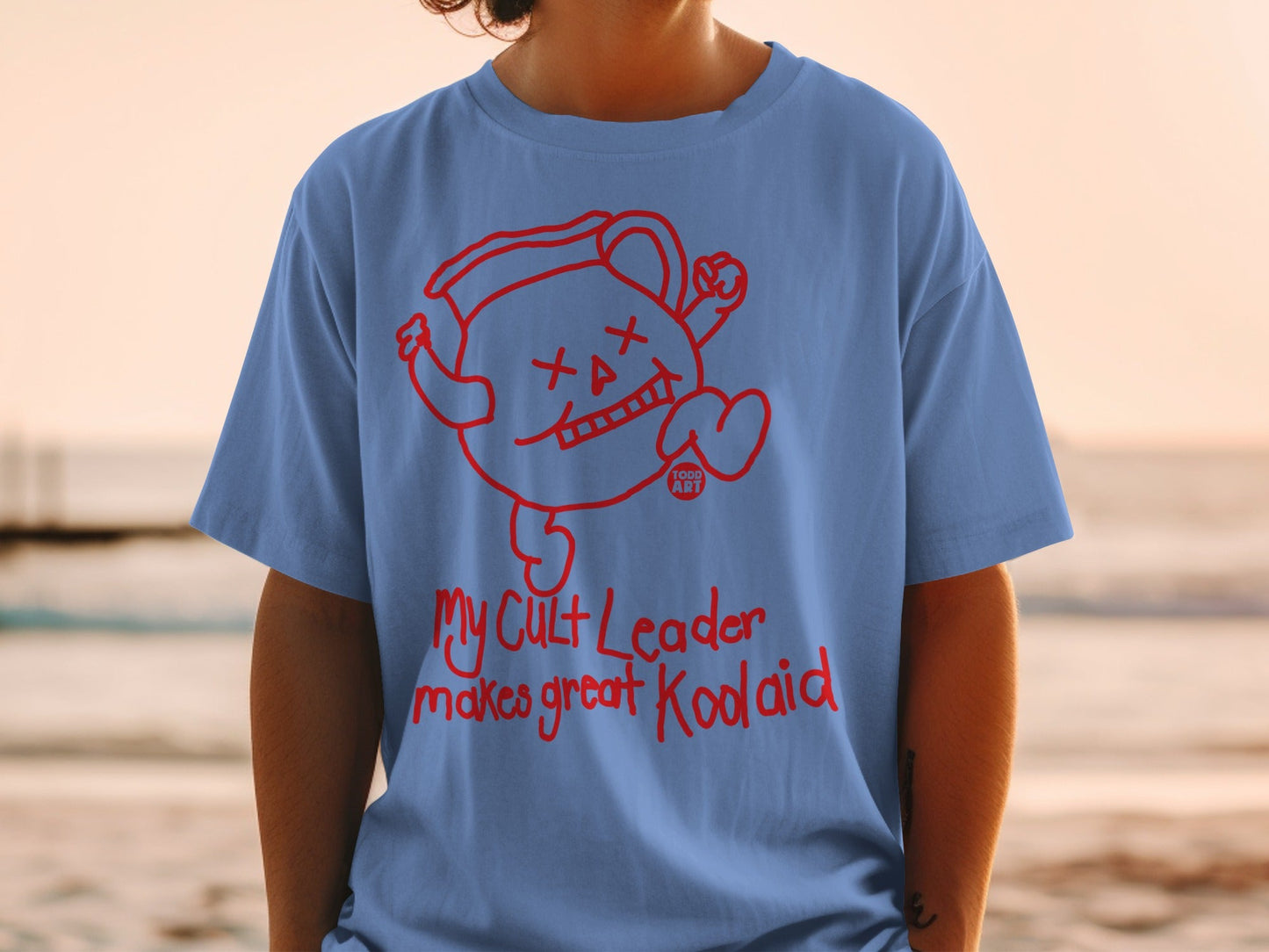 Blue t-shirt with red Kool-Aid man graphic and "My Cult Leader makes great Kool-Aid" text.