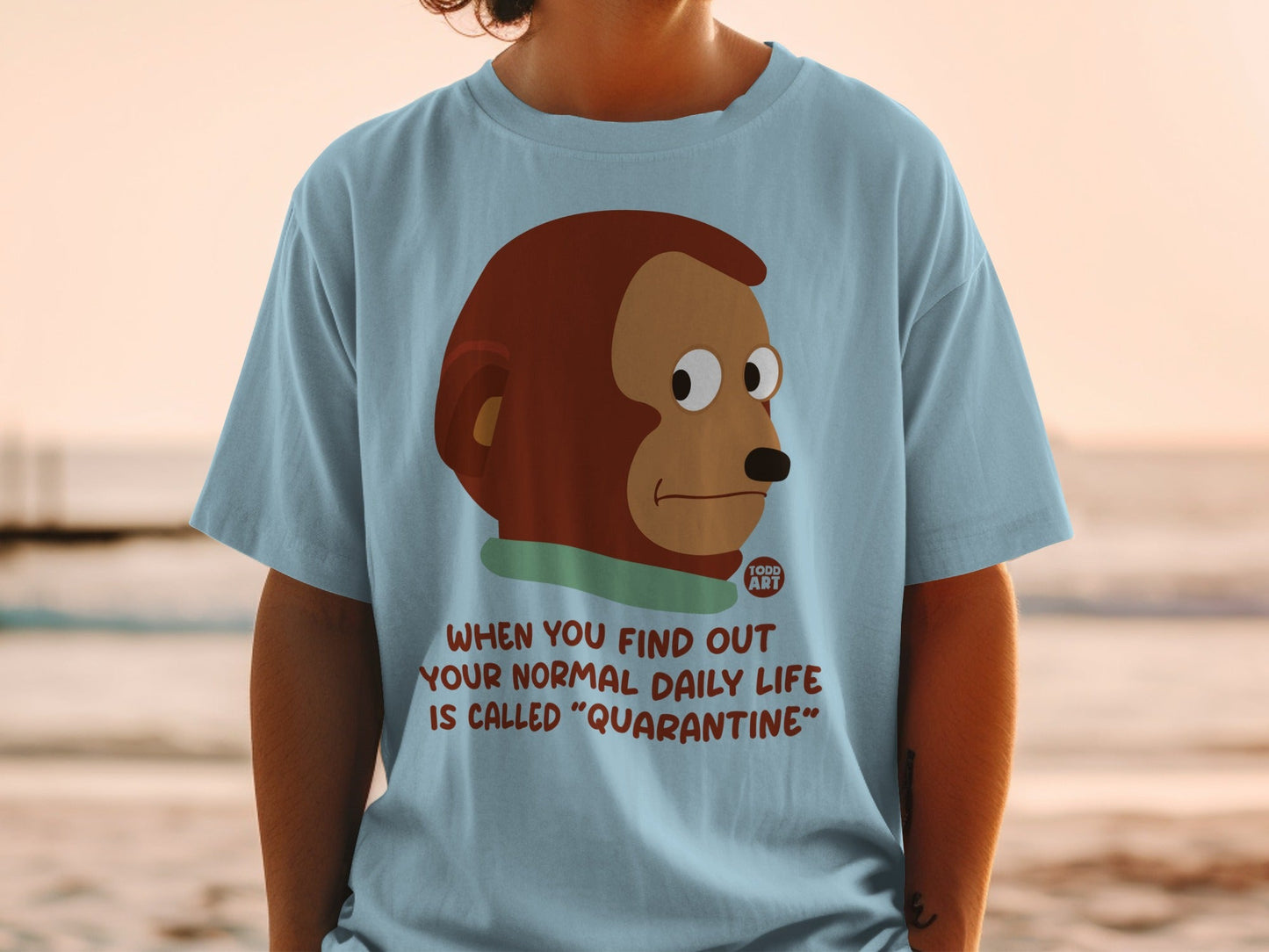 Light blue t-shirt with monkey cartoon and quarantine text.