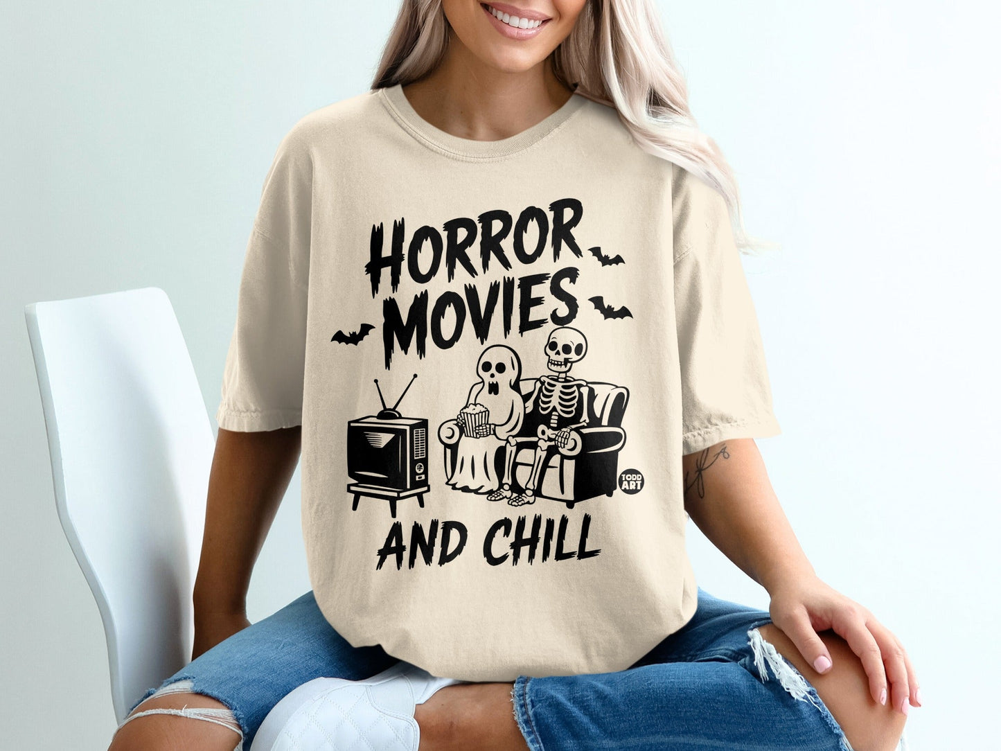 Skeleton couple watching horror movies on couch, "Horror Movies And Chill".