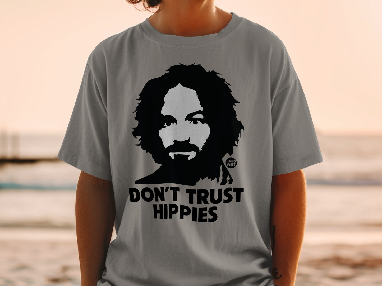 Gray t-shirt with Charles Manson graphic and "DON'T TRUST HIPPIES" text.