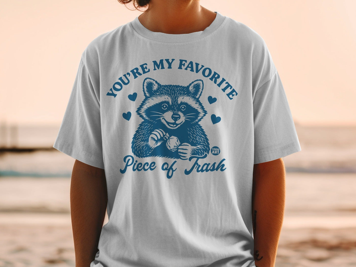 T-shirt with raccoon illustration and "You're My Favorite Piece of Trash" text.