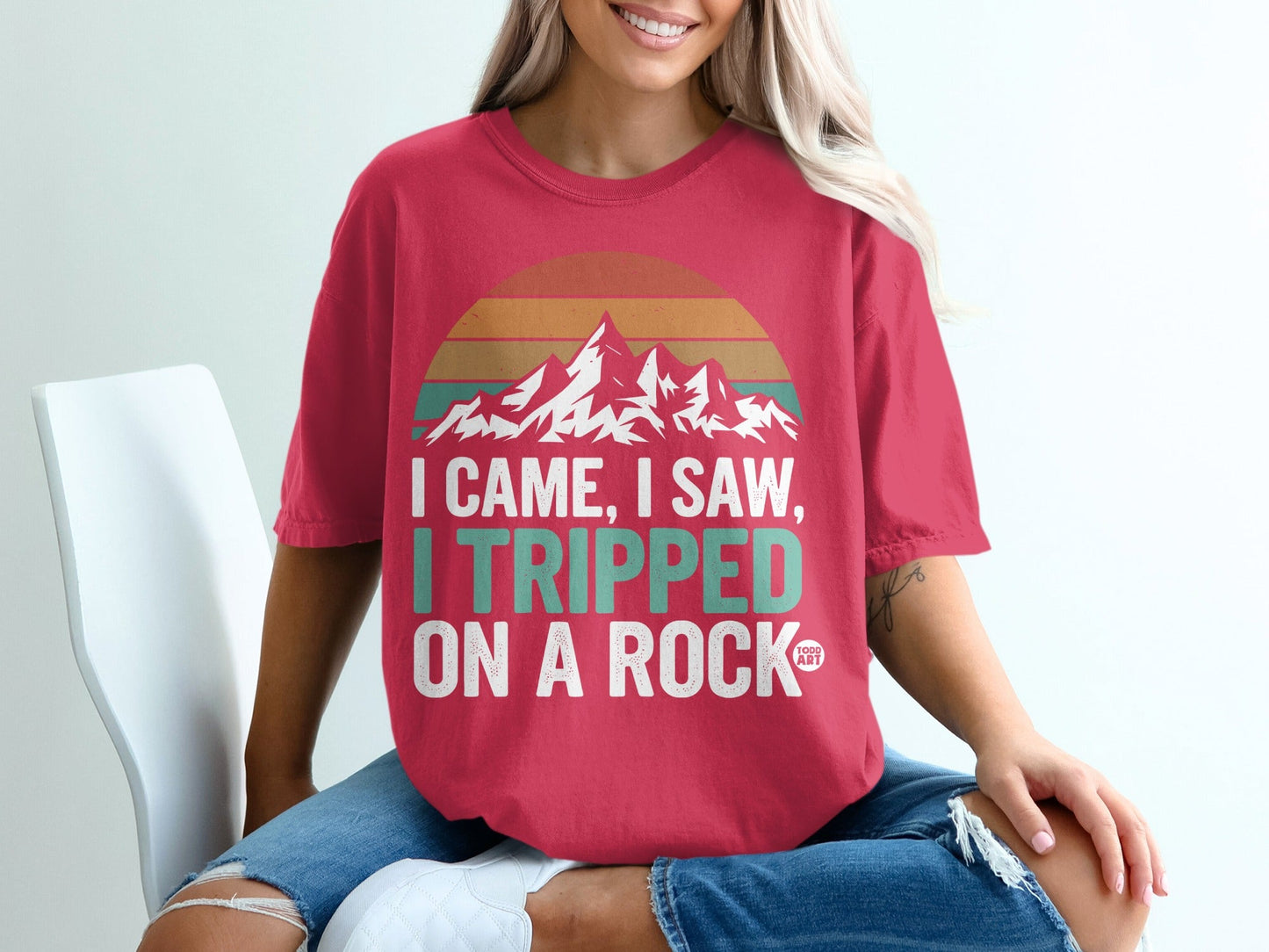 Red t-shirt with mountains and "I came, I saw, I tripped on a rock" text.