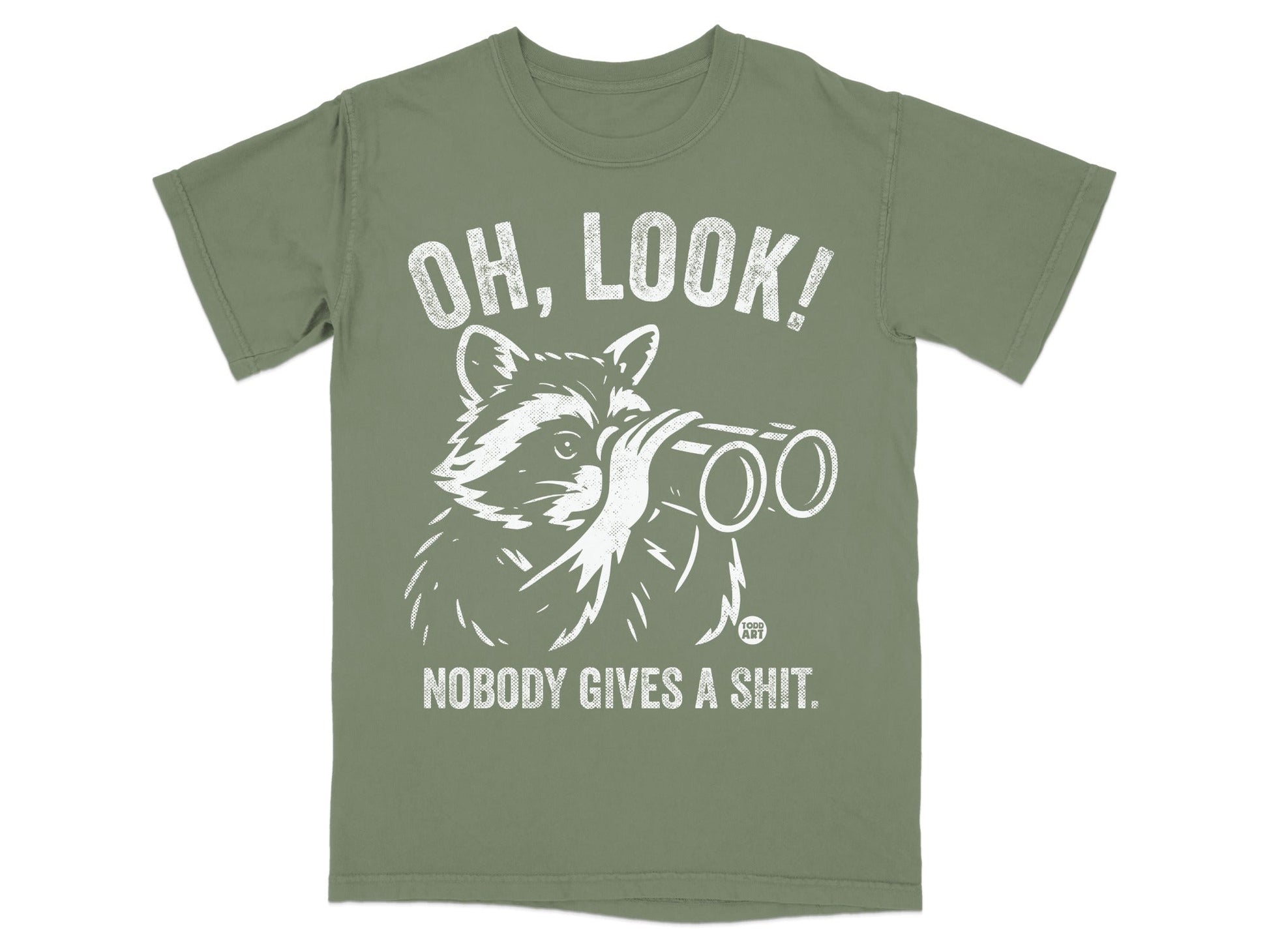 White raccoon wearing glasses looks through binoculars on a green t-shirt with text.