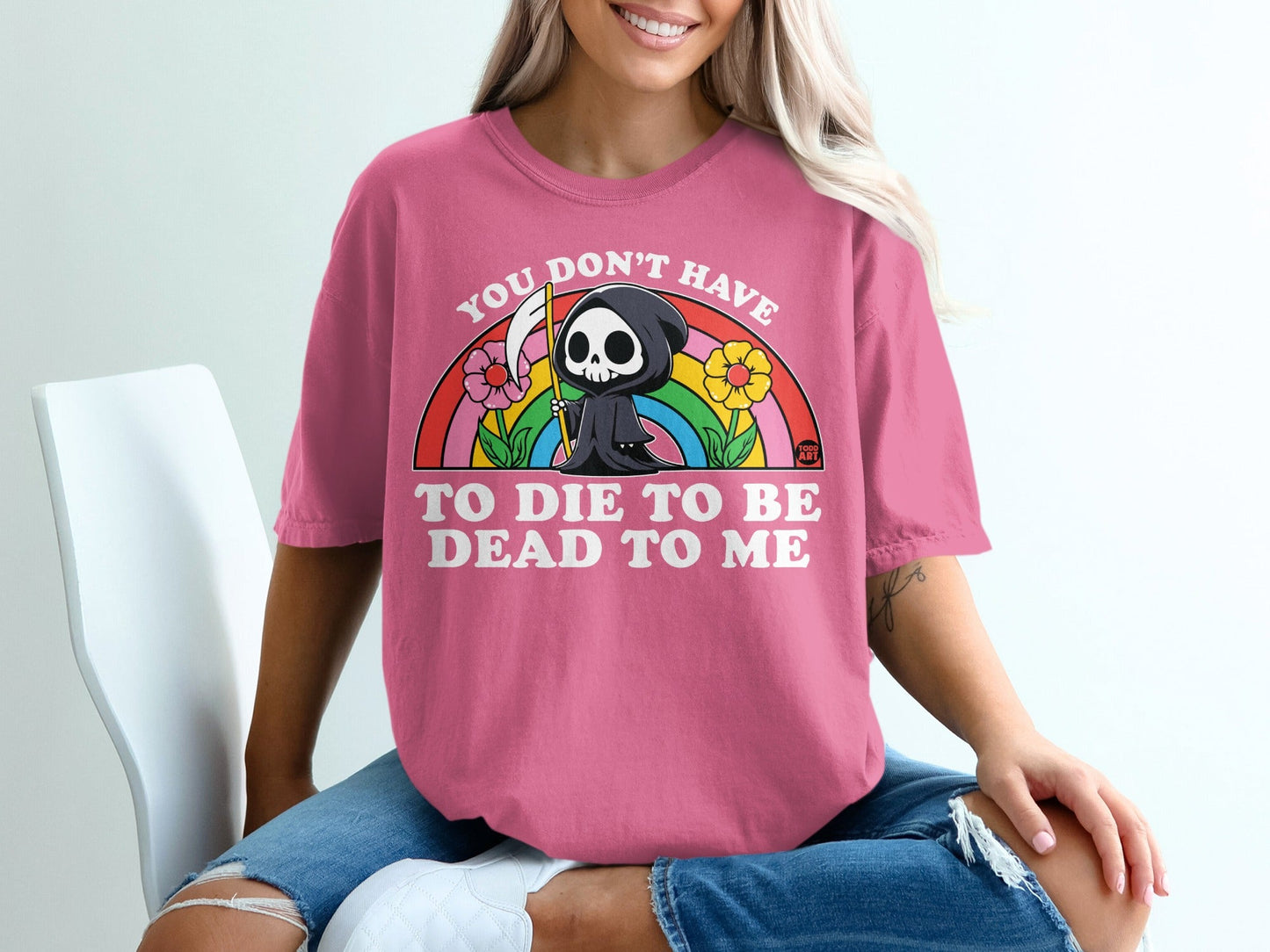 Pink t-shirt with Grim Reaper, flowers, and rainbow graphic.