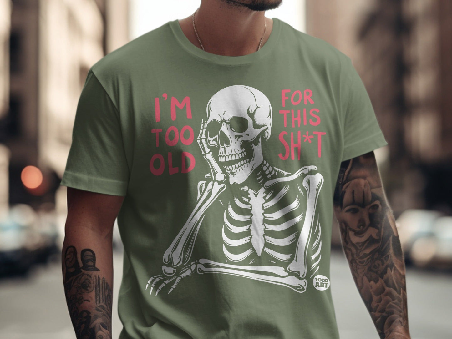 Olive t-shirt with a skeleton graphic and text "I'm TOO OLD FOR THIS SH*T".